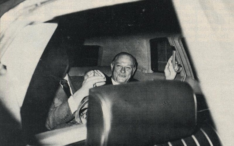 Summa counsel Chester Davis in the back seat of a car, taken from outside of the passenger window. 