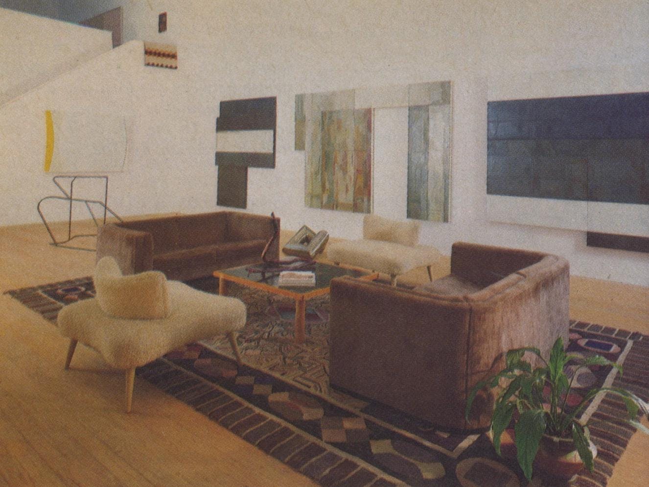 The simple furnishings of the living room are set off by a large 19th-century French Canadian hooked rug. The new three-piece oil painting by David Novros has been hung to dry and is for sale. On the floor are metal sculptures by Clark Murray. A snakeroot sculpture sits on a “tea table” by Billy Al Bengston, and Jo Baer's “M. Refractarius” hangs on the stairwell wall.