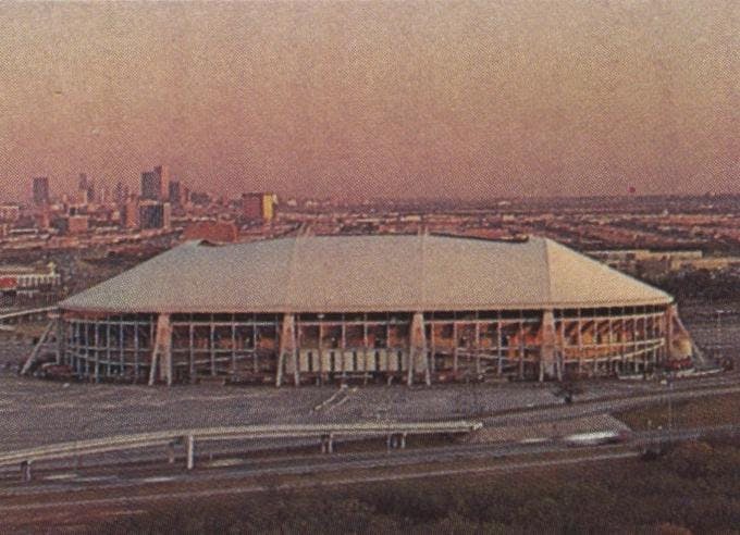 Texas Stadium against the Dallas skyline.