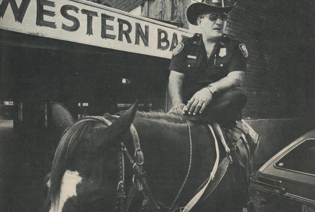 Some things never change. Justice in Cowtown is meted out by a lawman sitting tall in the saddle—J. D. Powers.