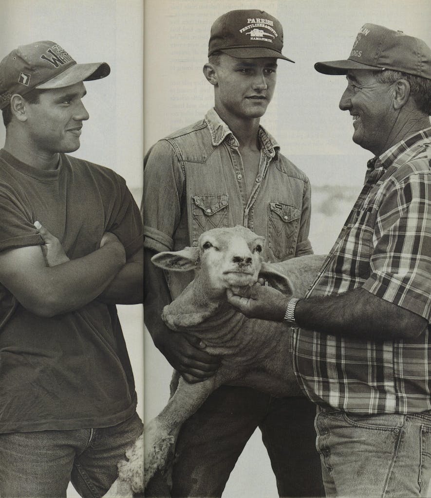 Sheep rancher and team coach Leonard Buffe, with his son Landon (center) and Petey Salaiz, who lives with the Buffes. After practice, the boys do chores together. 