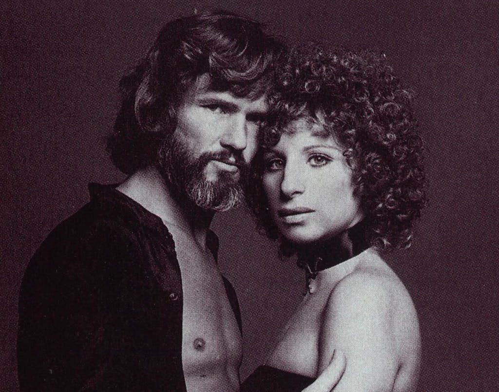 Kristofferson and Barbara Streissand stand facing each other.