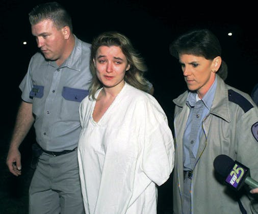 Darlene Routier being taken in by police after being arrested for murder. 
