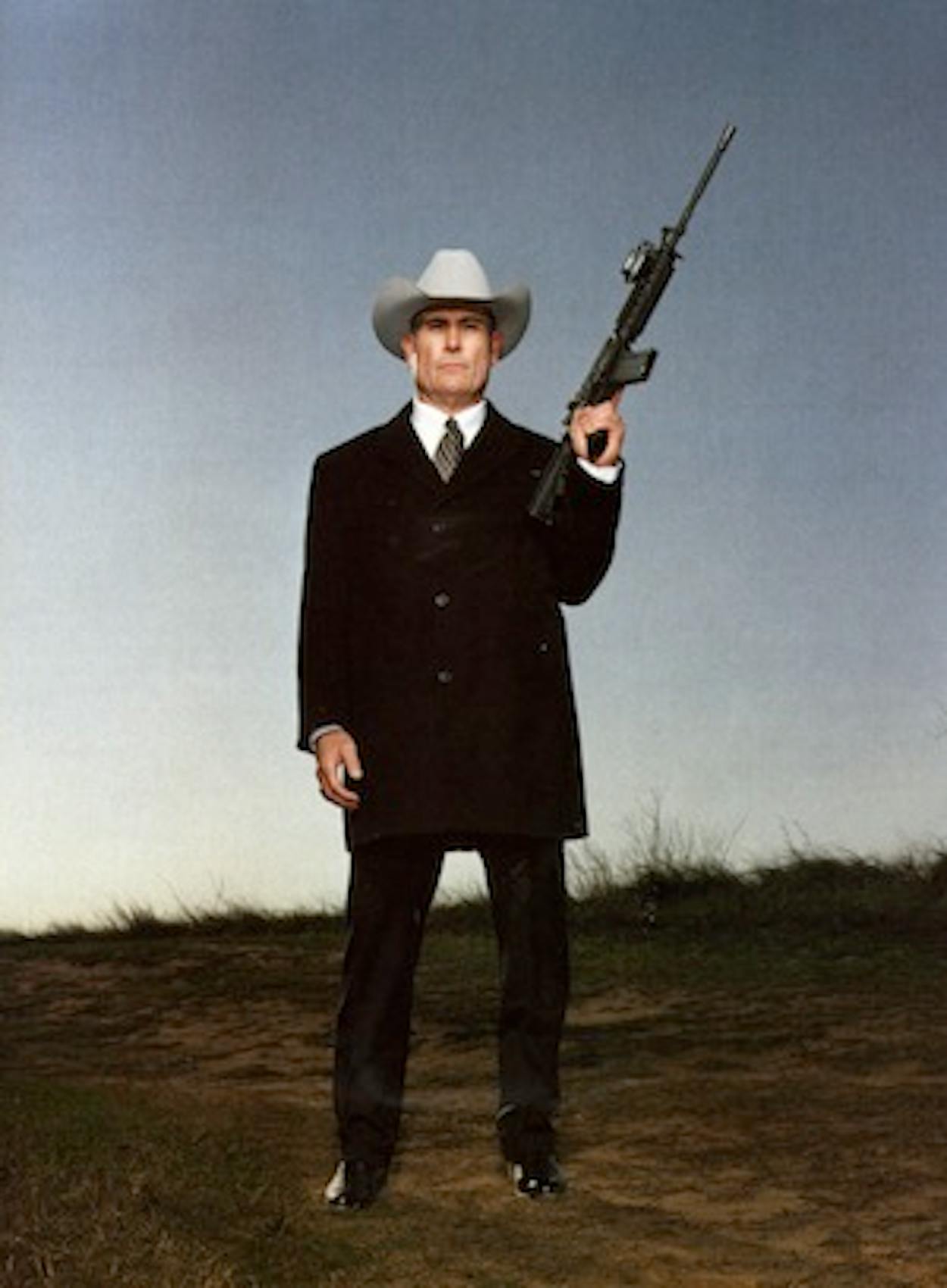 Clete Buckaloo standing tall with a gun over one shoulder.