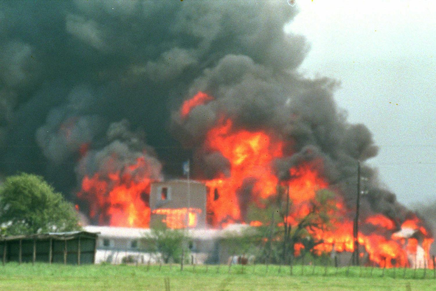 Branch Davidian Compound in Flames, surrounded by thick black smoke. 