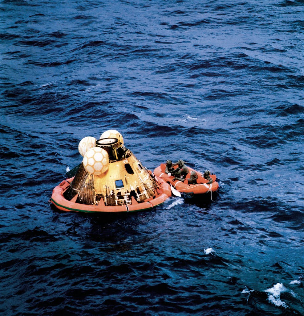 The astronauts prepare for a helicopter to pick them up shortly after splashdown in the Pacific Ocean southwest of Hawaii.