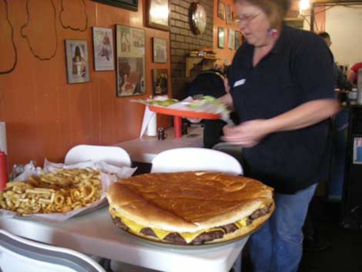 Waitress serving a 24-inch burger.