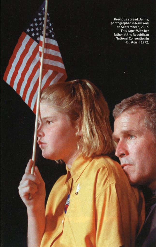 Young Jenna Bush holding the American flag, with her father behind her. 