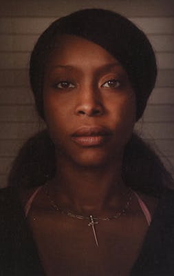 Somber headshot of Erykah Badu. 