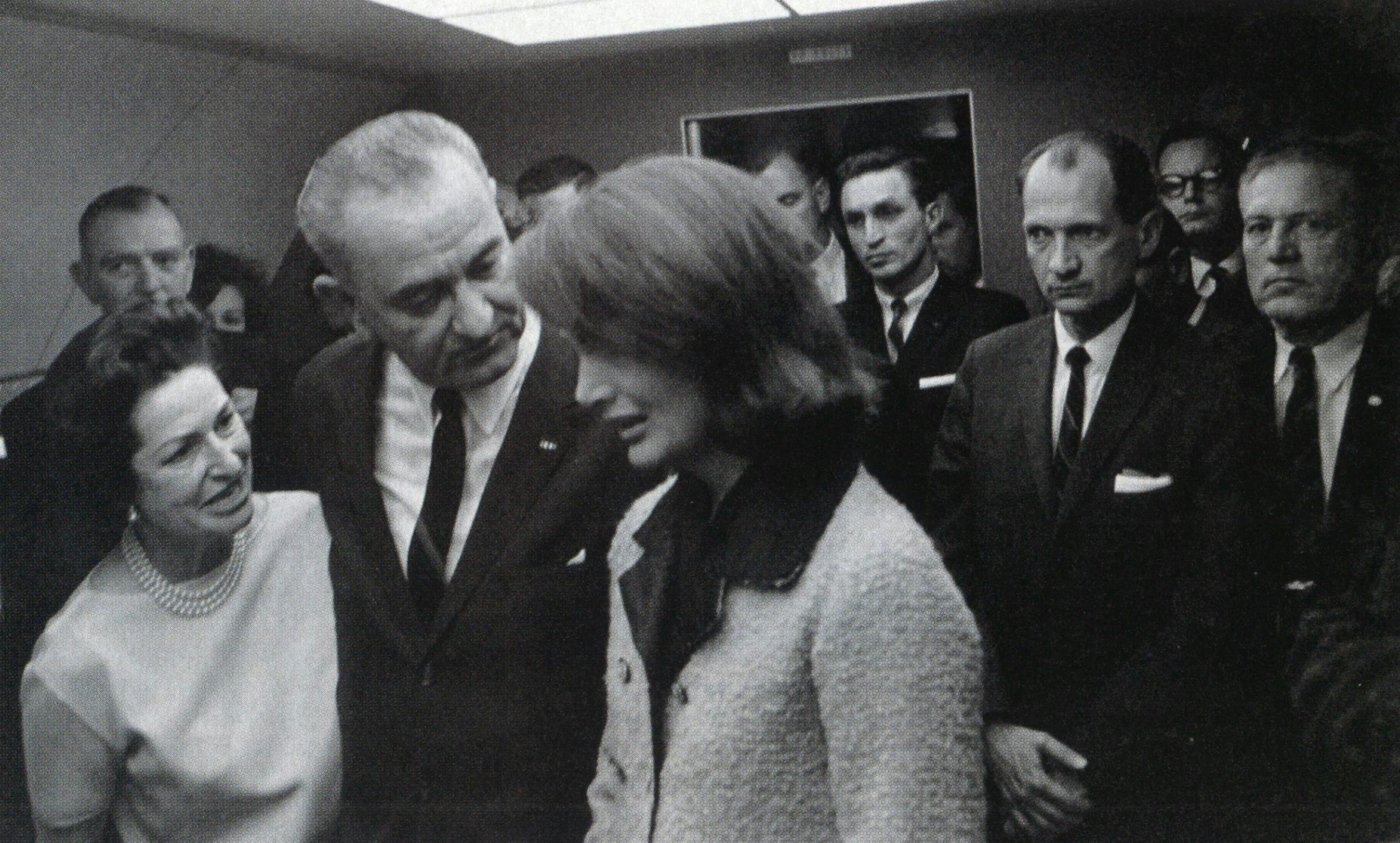 Shortly after the murder of President Kennedy, Lady Bird and LBJ comfort Mrs. Kennedy aboard Air Force One. Johnson later denied accusations that he had been insensitive to the Kennedy family after the tragedy.