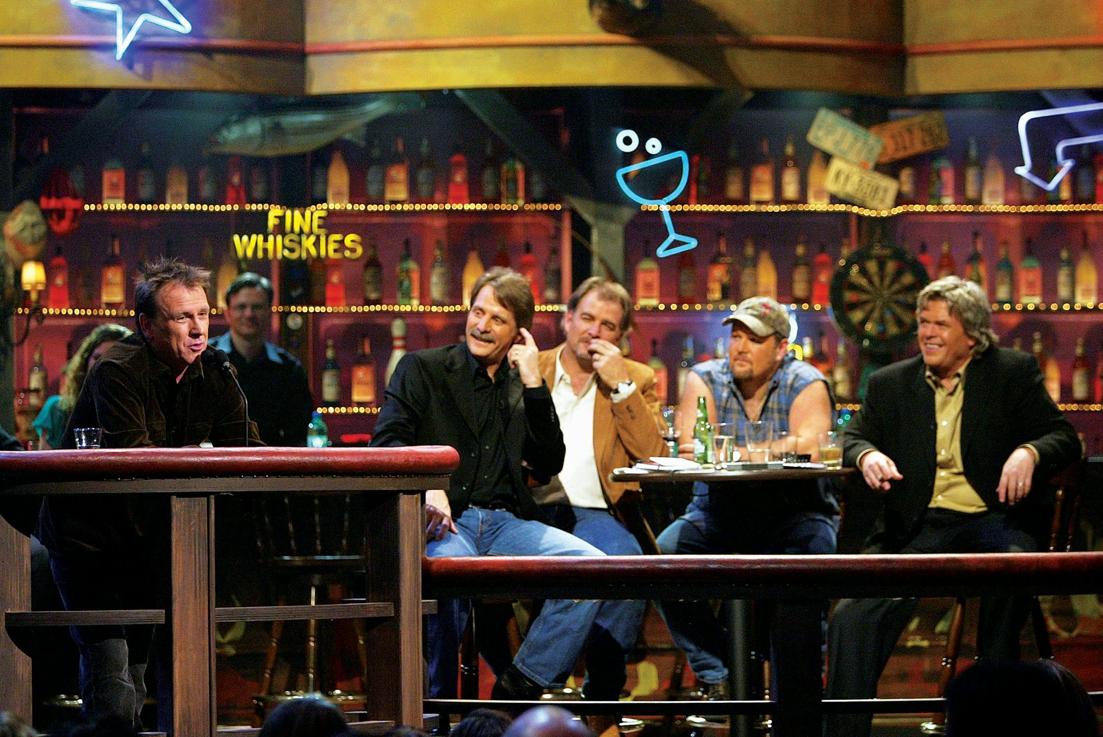 Foxworthy, Bill Engvall, Larry the Cable Guy, and White watching as Colin Quinn performs at a roast in 2004.
