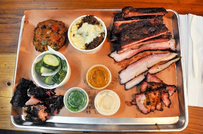BBQ Tray with brisket mac and cheese, pickles, and sauces from Fletchers