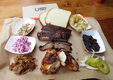 BBQ tray with meat, bread, and sides from horse thief BBQ. 