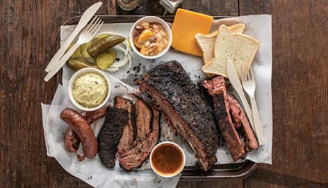 Loaded BBQ Tray with brisket, ribs, sausage, and sides from Louie Mueller Barbecue