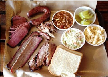 BBQ Tray with meat, bread, beans, cole slaw, mac and cheese, and pickles from Smoke City