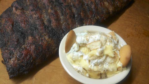 Banana pudding next to barbecue meat. 