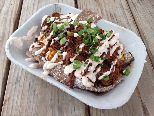 Baked potato stuffed with barbecue and drizzled with cream cheese. 