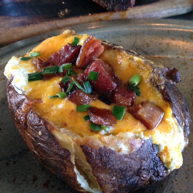 Buttery potato with melted cheese, chives, and whole strips of bacon. 