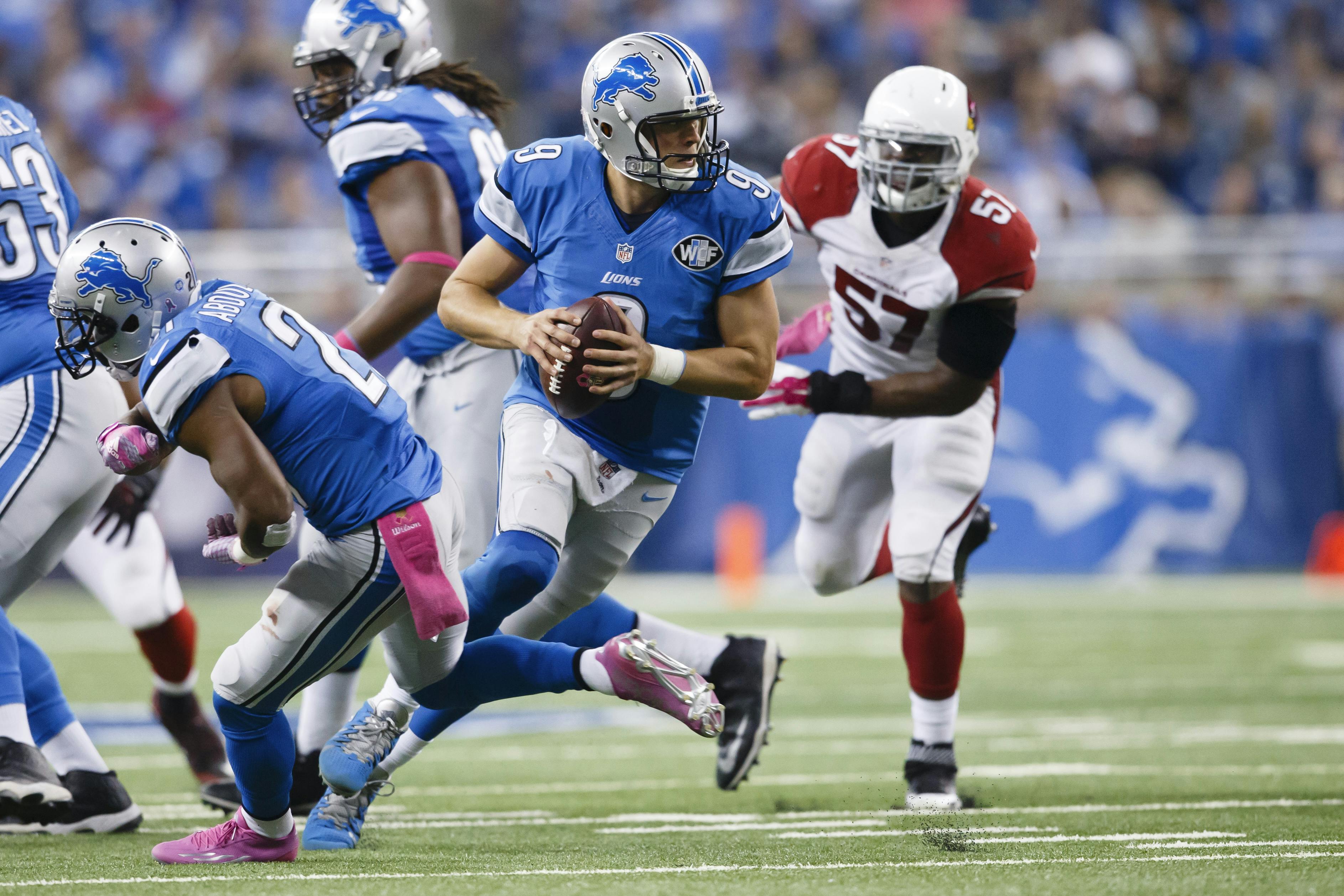Detroit Lions quarterback Matthew Stafford (9) rolls out to pass against the Arizona Cardinals during an NFL football game at Ford Field in Detroit, Sunday, Oct. 11, 2015. (AP Photo/Rick Osentoski)