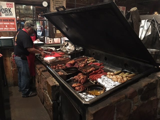 BBQ, meats, and sides on a big buffet. 