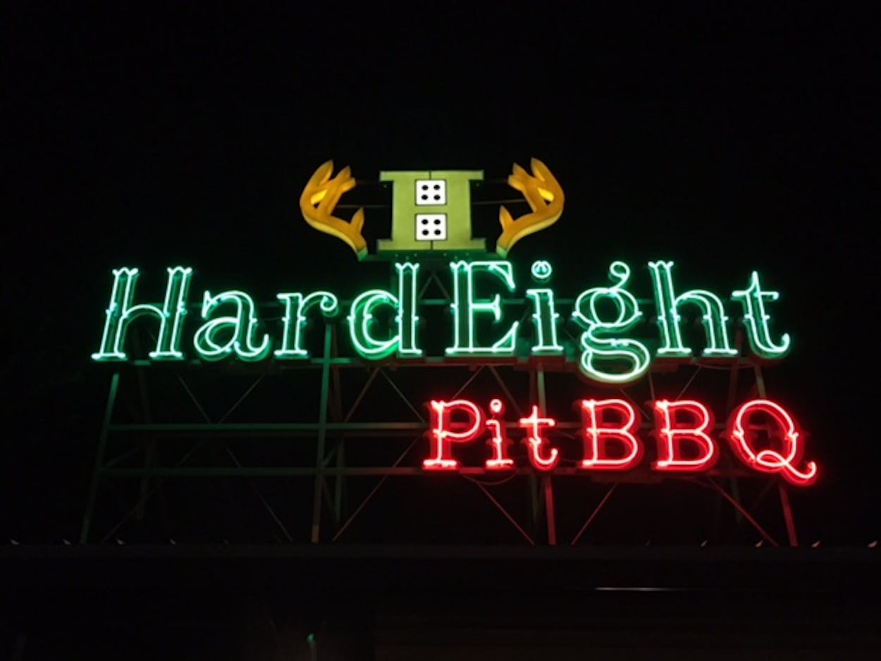 Hard Eight Pit BBQ's light up sign in the dark.