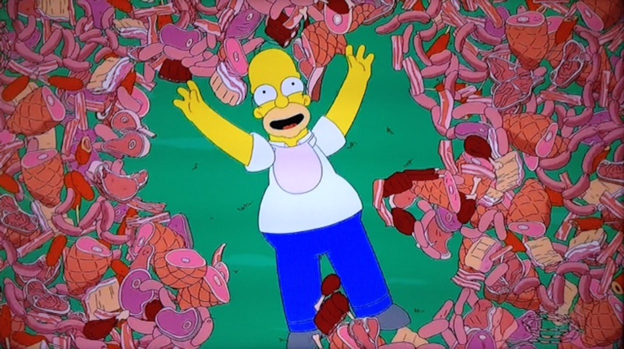 Homer Simpson surrounded by barbecue meat.
