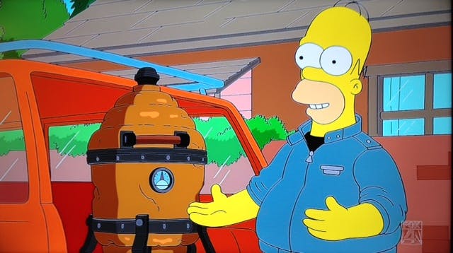 Homer Simpson showing off his new BBQ smoker. 