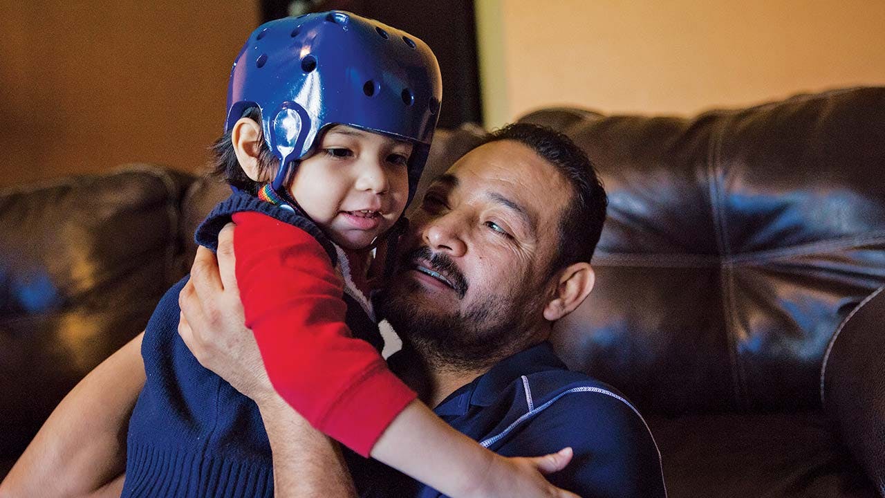 Rikki Adan, another participant in Cook Children’s clinical trial, suffered more than thirty seizures a day before he joined the trial. He wears a helmet to protect against injury. 