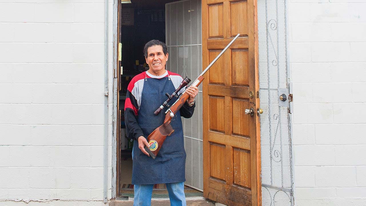 Jesus “Chuy” Aguirre outside his shop, in El Paso, on January 5, 2016, holding one of his own guns.