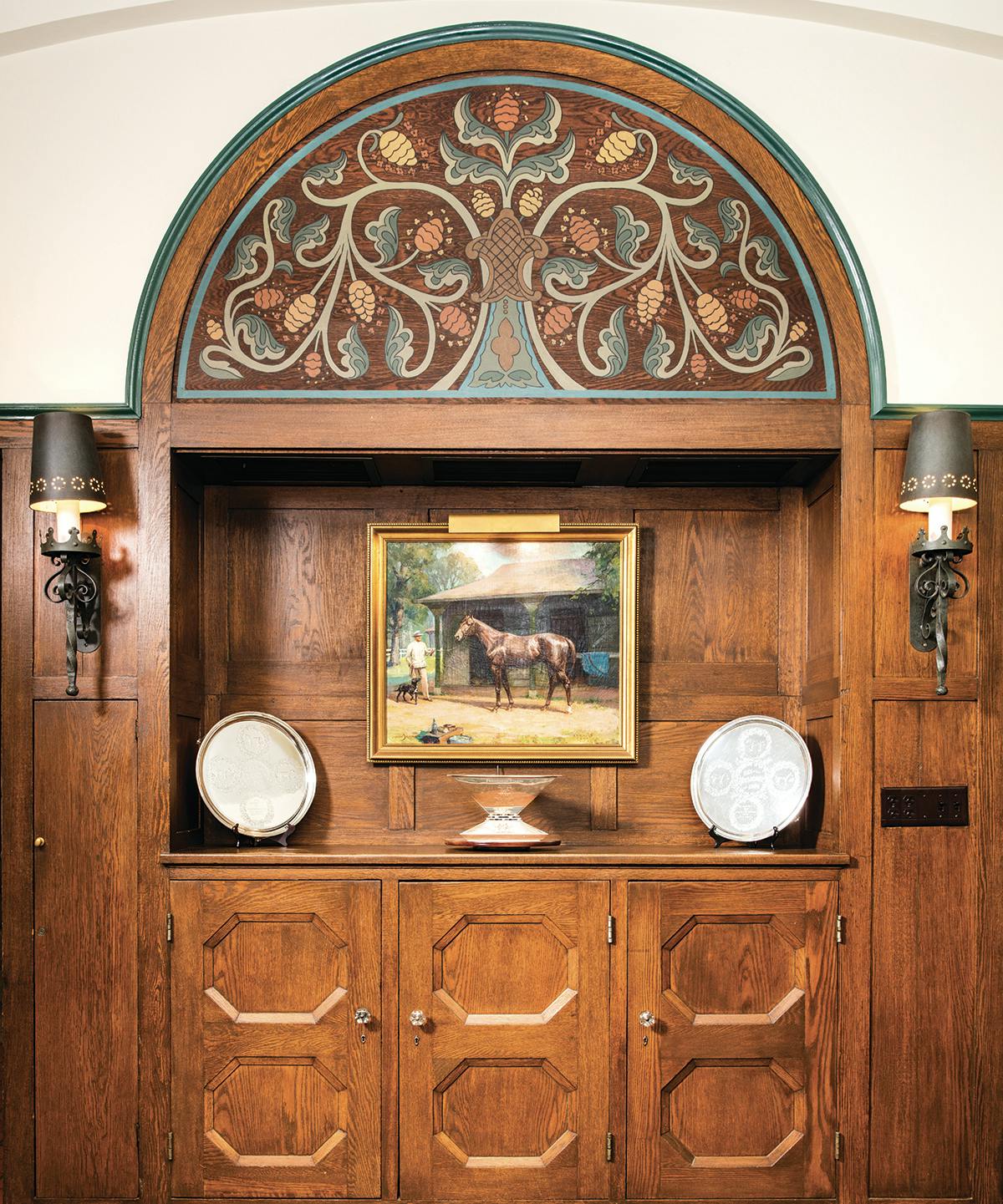 A Tiffany-designed China cabinet in the dining room now serves as a display case for the Belmont Stakes trophies won by King Ranch Thoroughbreds and for the Triple Crown trophy won by Assault.