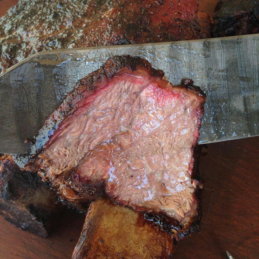 Cross section of a juicy beef rib with a deep pink smoke ring. 
