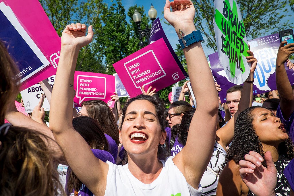 WASHINGTON, DC - JUNE 27: Abortion rights activist Morgan Hopkins of Boston, celebrates on the steps of the United States Supreme Court on June 27, 2016 in Washington, DC. In a 5-3 decision, the U.S. Supreme Court struck down one of the nation's toughest restrictions on abortion, a Texas law that women's groups said would have forced more than three-quarters of the state's clinics to close. 