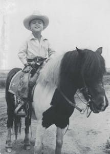 Larry McMurtry as a boy on his family’s ranch, sitting on his first pony.