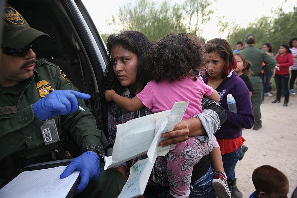 Immigrant Melida Patricio Castro from Honduras shows a birth certificate for her daughter Maria Celeste, 2, to a U.S. Border Patrol agent near the U.S.-Mexico border on July 24, 2014 near Mission, Texas.