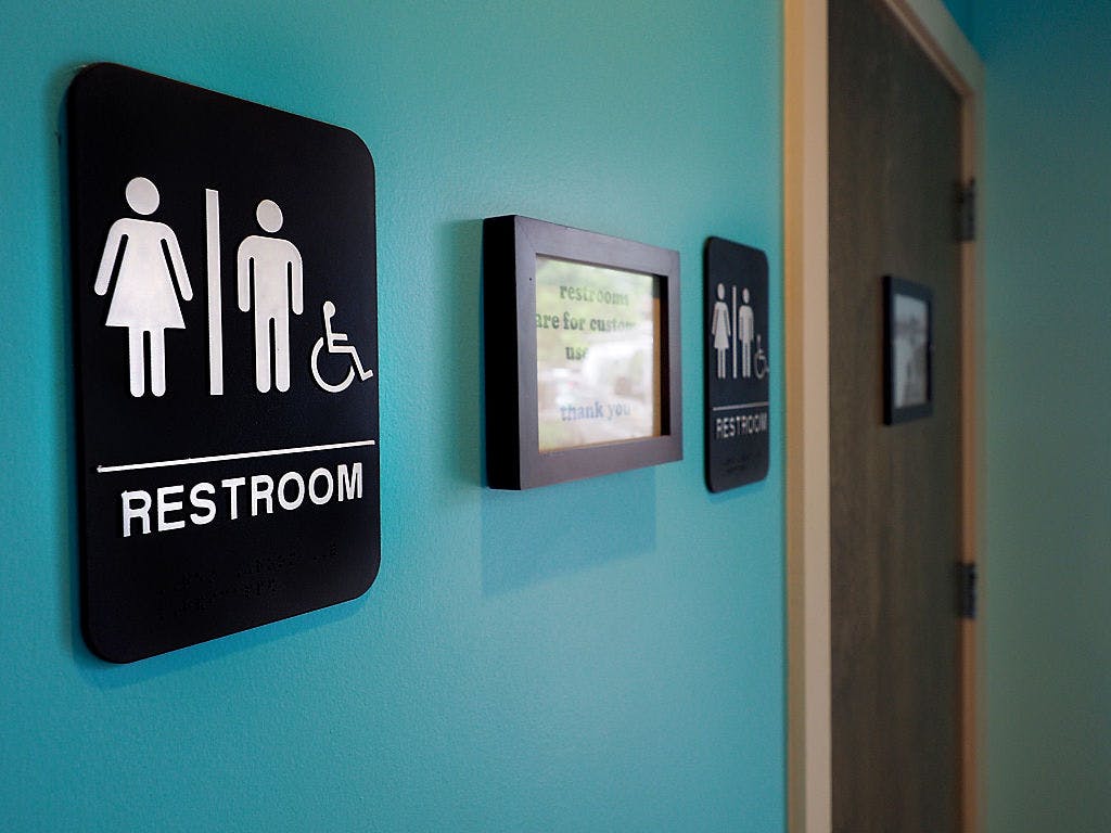 Unisex signs hang outside bathrooms May 10, 2016 in Durham, North Carolina. 