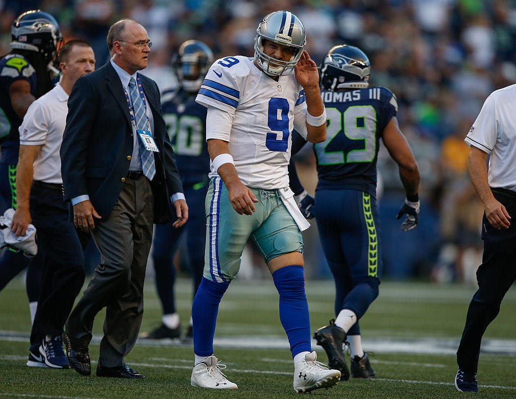 Quarterback Tony Romo #9 of the Dallas Cowboys leaves the field after being injured in the first quarter during a preseason game against the Seattle Seahawks at CenturyLink Field on August 25, 2016 in Seattle, Washington. 