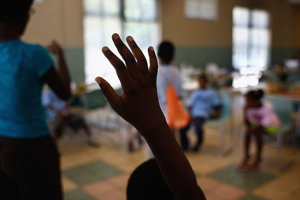 A child asks a question during daycare play events at the Center of Hope shelter for homeless women and children on June 16, 2009 in Dallas, Texas.