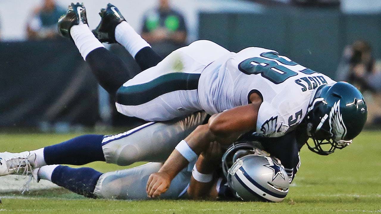 Philadelphia Eagles linebacker Jordan Hicks slams Romo to the turf, rebreaking his clavicle, on September 20, 2015. opposite page: Romo celebrates a touchdown—one of five—against the Denver Broncos on October 6, 2013, a game in which he threw for more than 500 yards.