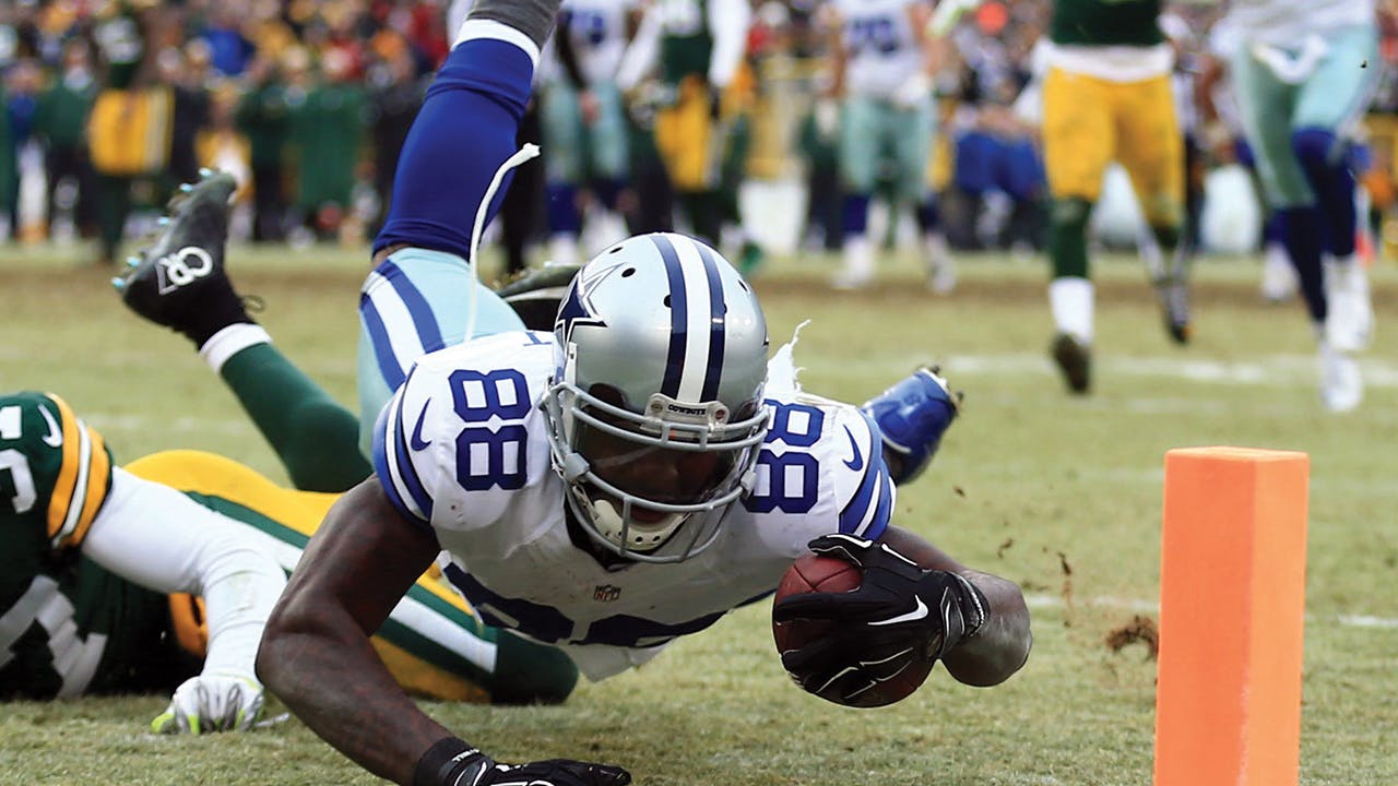 With less than five minutes left in the game against the Green Bay Packers on January 11, 2015, wide receiver Dez Bryant catches a deep pass from Romo and falls just short of the end zone— until, after a challenge by the Packers, the pass is ruled incomplete. 