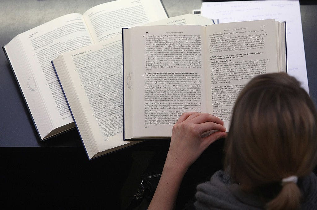 A student studies textbooks in the law faculty at Humboldt University prior to the beginning of the winter semester on October 11, 2011 in Berlin, Germany. 