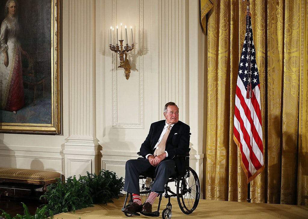 WASHINGTON, DC - JULY 15: Former President George H. W. Bush sits in a wheelchair during an event in the East Room at the White House, July 15, 2013 in Washington, DC. 