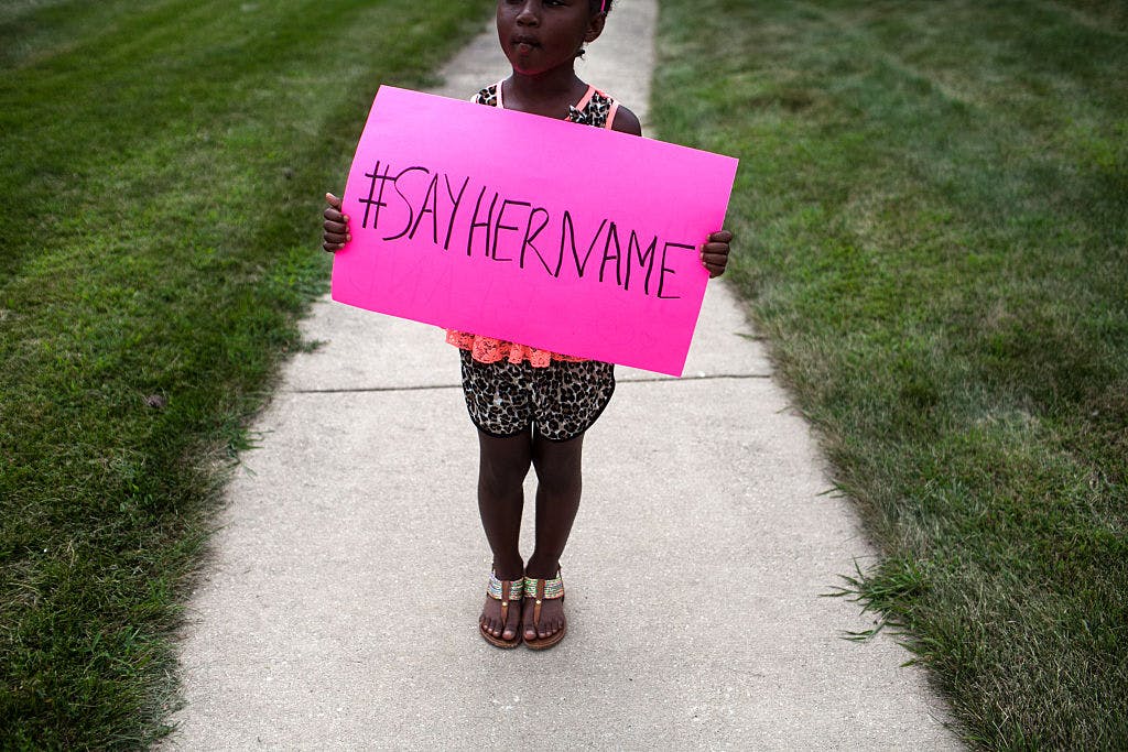 Daija Belcher, 5, holds a sign in front of the DuPage African Methodist Episcopal Church during the funeral service for Sandra Bland on July 25, 2015 in Lisle, Illinois. 