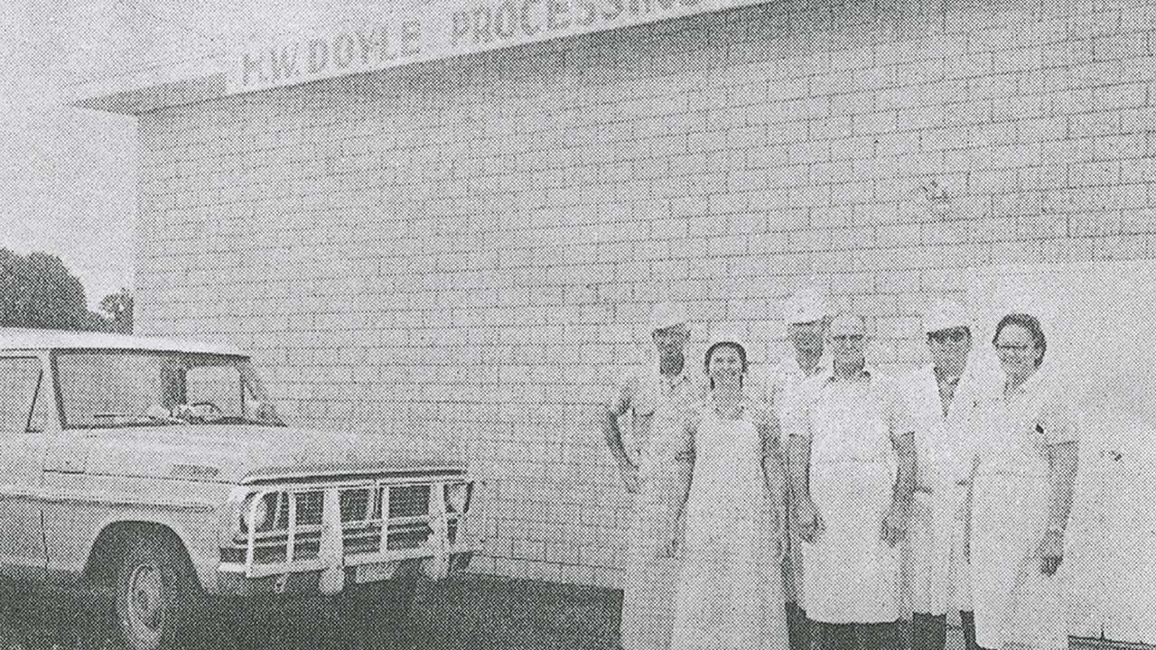 A 1974 newspaper photo of White (far left), Tootsie (second from left), and Hershel Doyle (fourth from left) with other market employees.