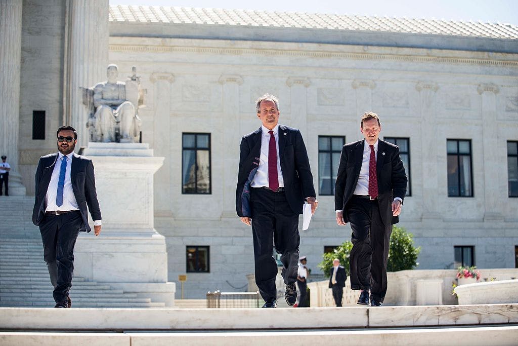 Texas Attorney General Ken Paxton (center) walks to a news conference outside the Supreme Court on Capitol Hill on June 9, 2016 in Washington, D.C.