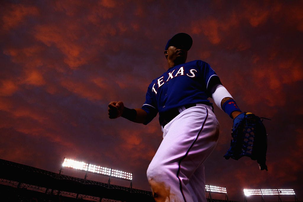 A Texas Rangers player returns to the dugout in the middle of the fourth inning as the Rangers take on the Colorado Rockies at Globe Life Park in Arlington on May 8, 2014 in Arlington, Texas. 