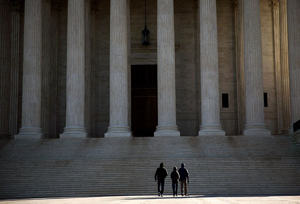 Visitors walk outside the U.S. Supreme Court on February 14, 2016 in Washington, DC.
