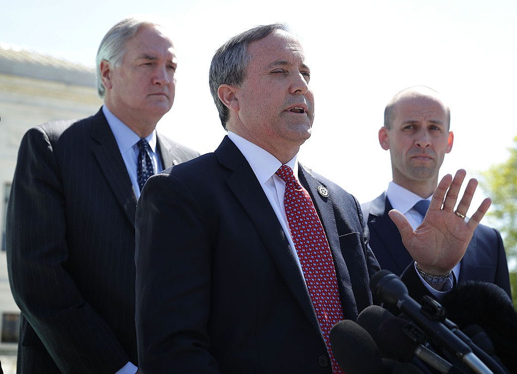 Texas Attorney General Kenneth Paxton (middle) speaks to members of the media in front of the U.S. Supreme Court April 18, 2016 in Washington, DC.
