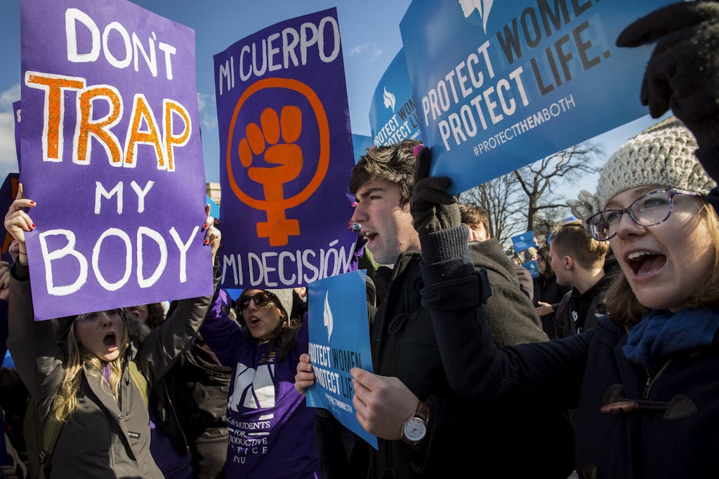 WASHINGTON, DC - MARCH 2: Pro-choice advocates (left) and anti-abortion advocates (right) rally outside of the Supreme Court, March 2, 2016 in Washington, DC. On Wednesday morning, the Supreme Court will hear oral arguments in the Whole Woman's Health v. Hellerstedt case, where the justices will consider a Texas law requiring that clinic doctors have admitting privileges at local hospitals and that clinics upgrade their facilities to standards similar to hospitals. (Drew Angerer/Getty Images)