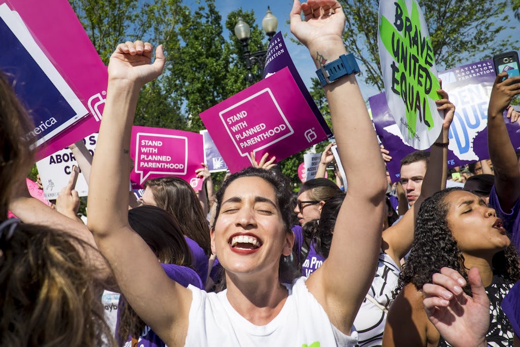 WASHINGTON, DC - JUNE 27: Abortion rights activist Morgan Hopkins of Boston, celebrates on the steps of the United States Supreme Court on June 27, 2016 in Washington, DC. In a 5-3 decision, the U.S. Supreme Court struck down one of the nation's toughest restrictions on abortion, a Texas law that women's groups said would have forced more than three-quarters of the state's clinics to close. (Photo by Pete Marovich/Getty Images)
