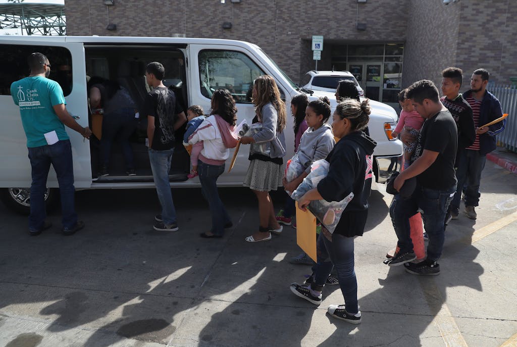 MCALLEN, TX - AUGUST 19: Immigrant families are transported to an "Immigrant Respite Center" after being released by the U.S. Border Patrol on August 19, 2016 in McAllen, Texas. After crossing the Rio Grande from Mexico into Texas, the families are taken into custody by the U.S. Border Patrol, given temporary legal documents and then sent by bus to their destination city in the United States, where they apply for political asylum. Many receive assistance from the Sacred Heart Catholic Church Immigrant Respite Center in McAllen before continuing their journey. (Photo by John Moore/Getty Images)
